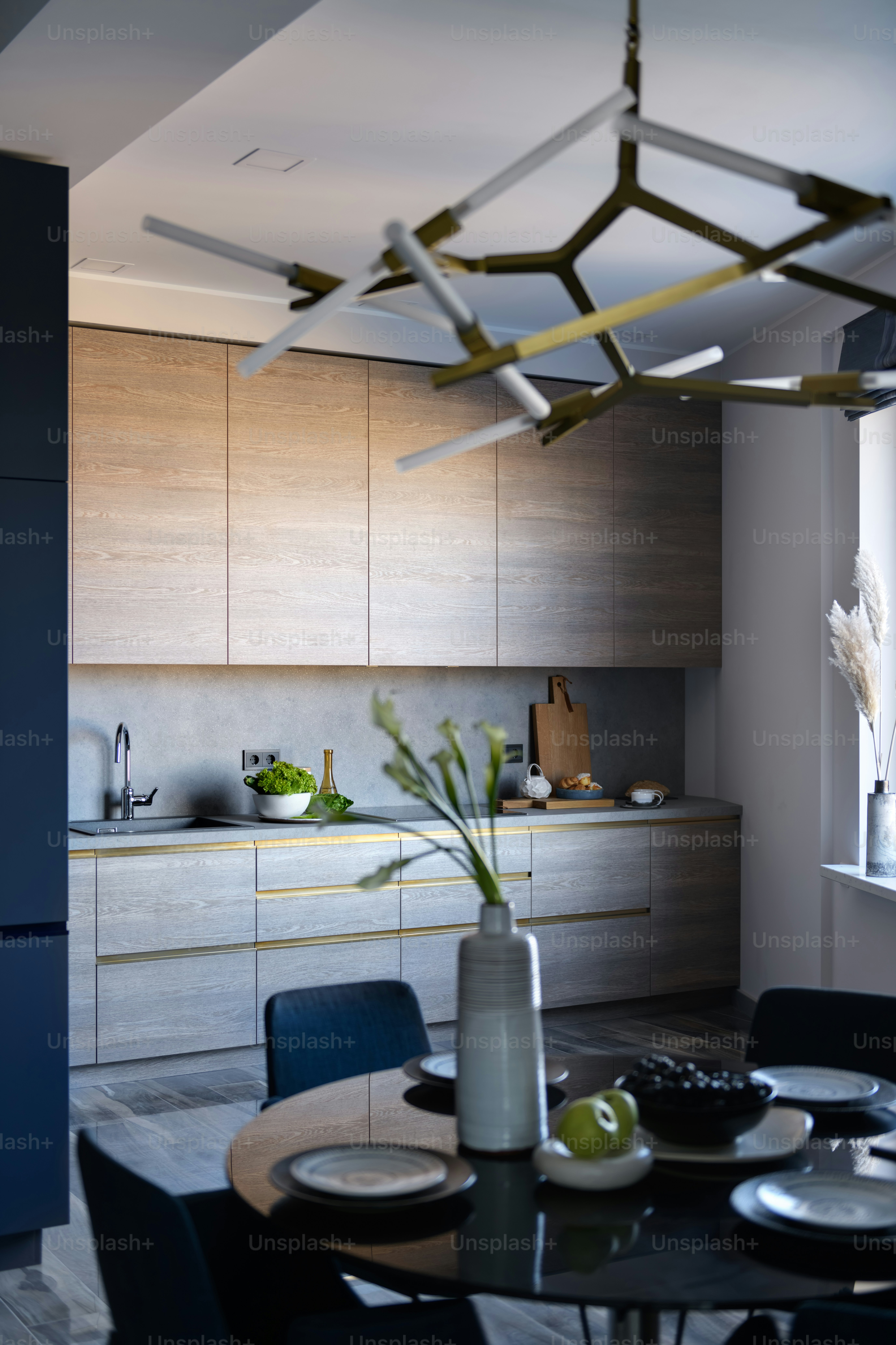 una cocina con una mesa y sillas y un jarrón con flores