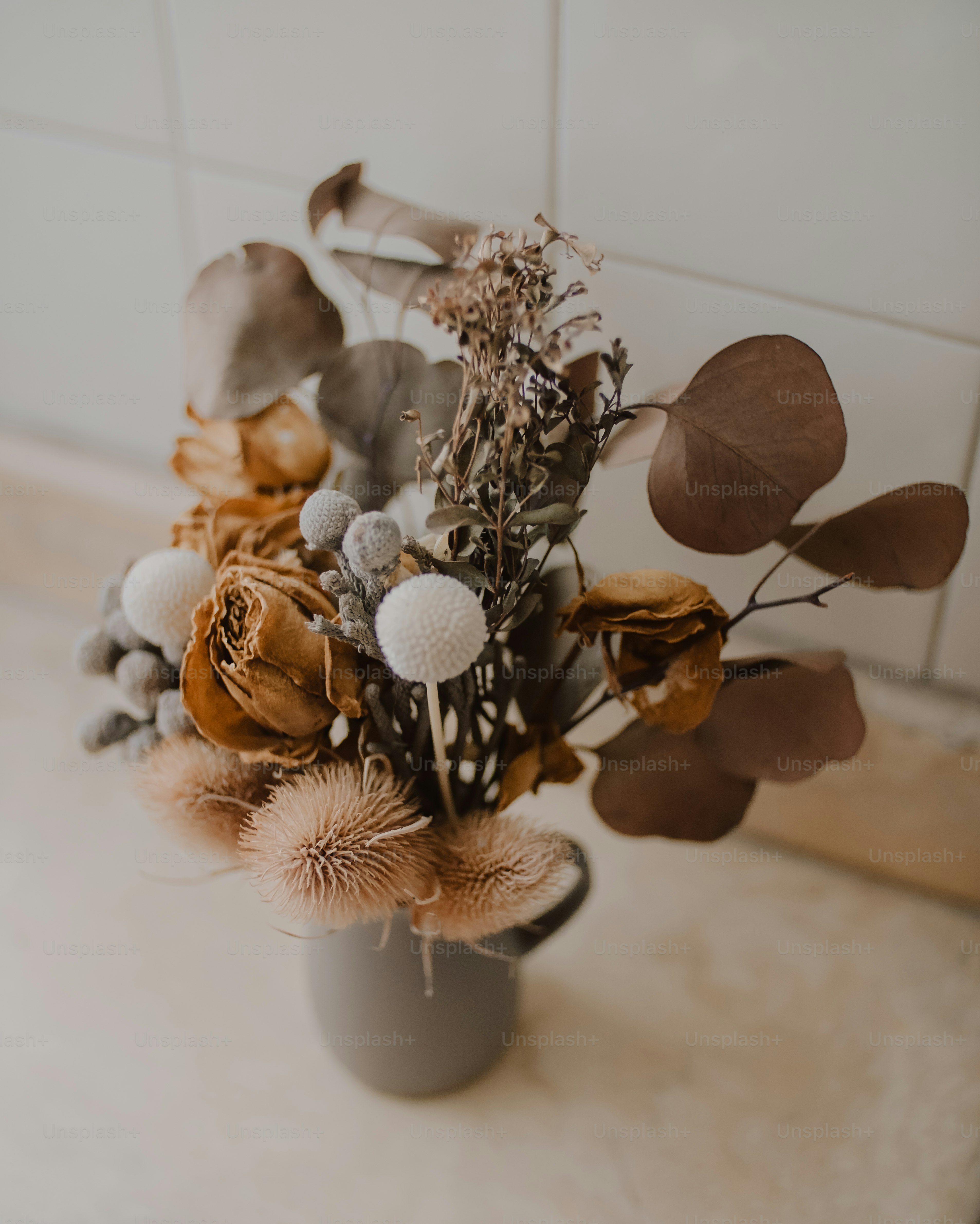 a vase filled with lots of different types of flowers