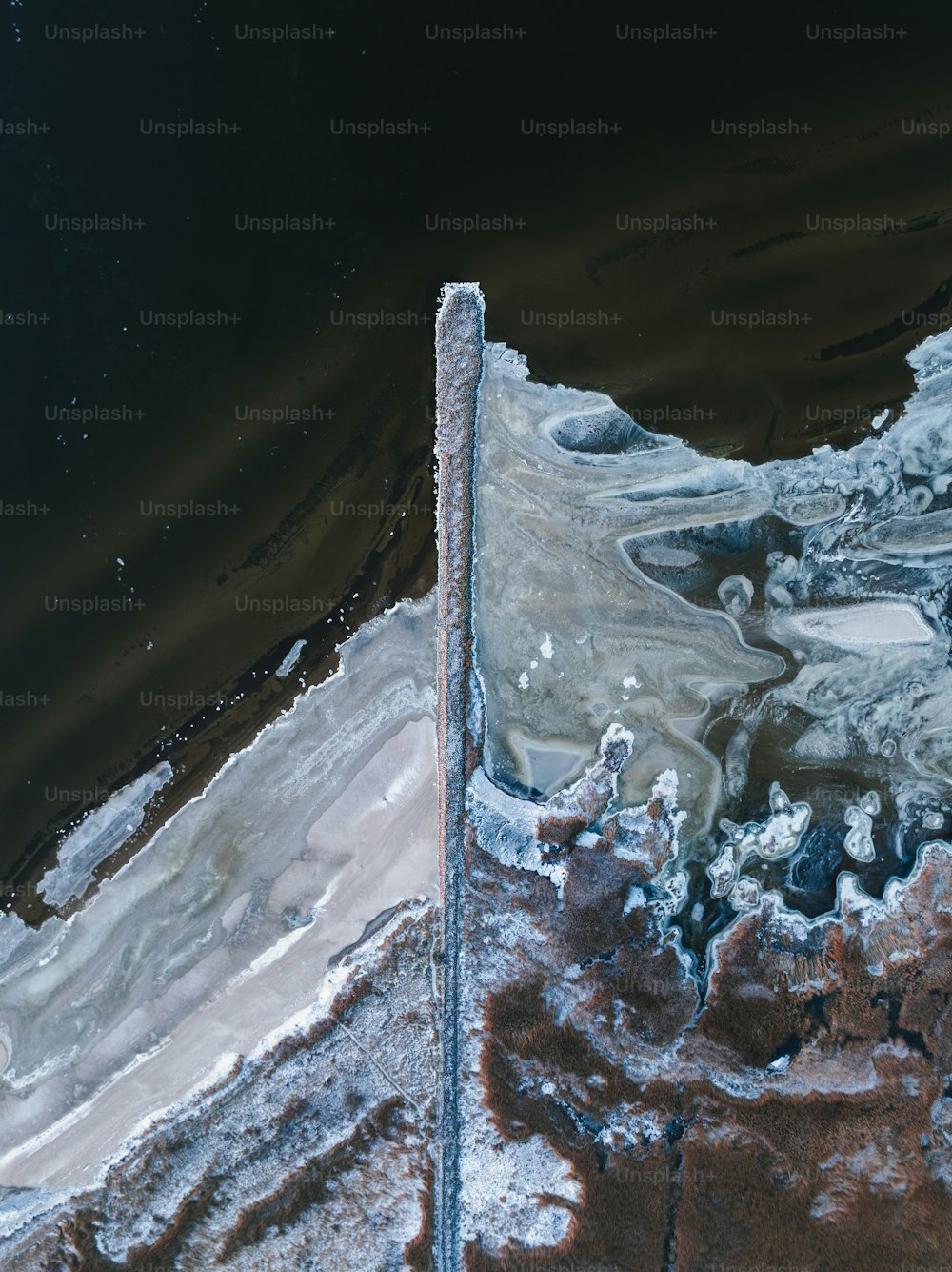 an aerial view of a body of water covered in ice