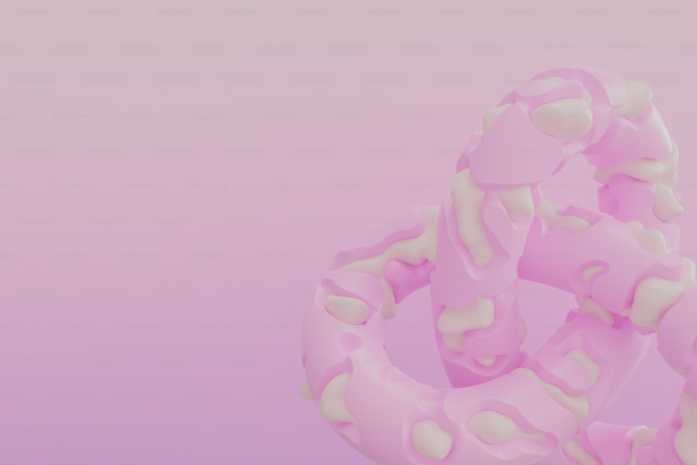 a close up of a doughnut on a pink background