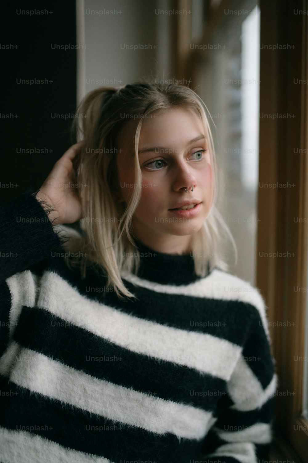 a woman in a black and white striped sweater