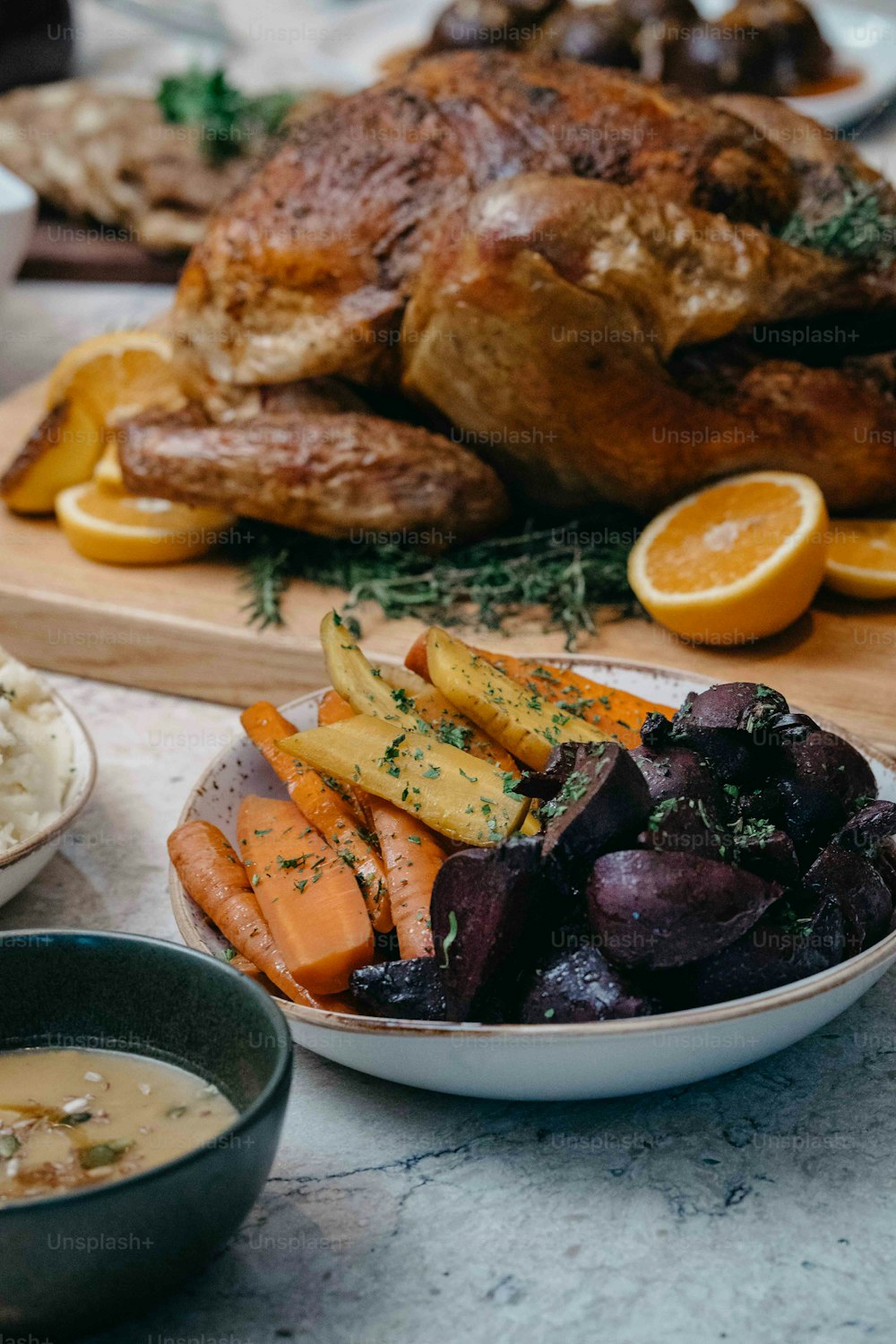 a plate of food with carrots, potatoes, and meat