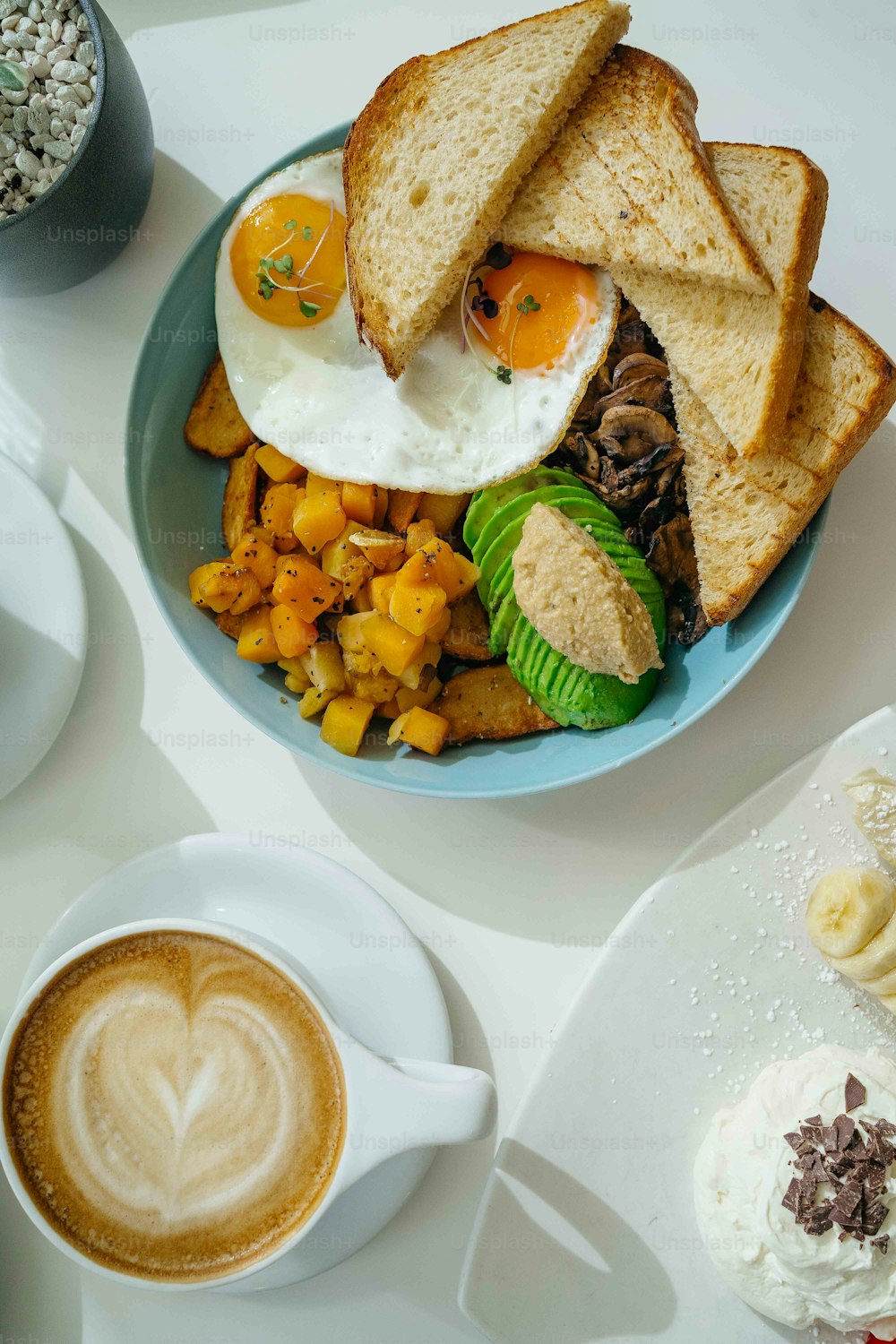 a plate of food and a cup of coffee on a table