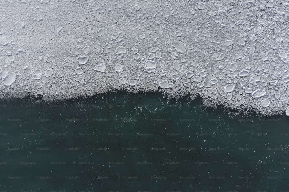 a large amount of ice floating on top of a body of water