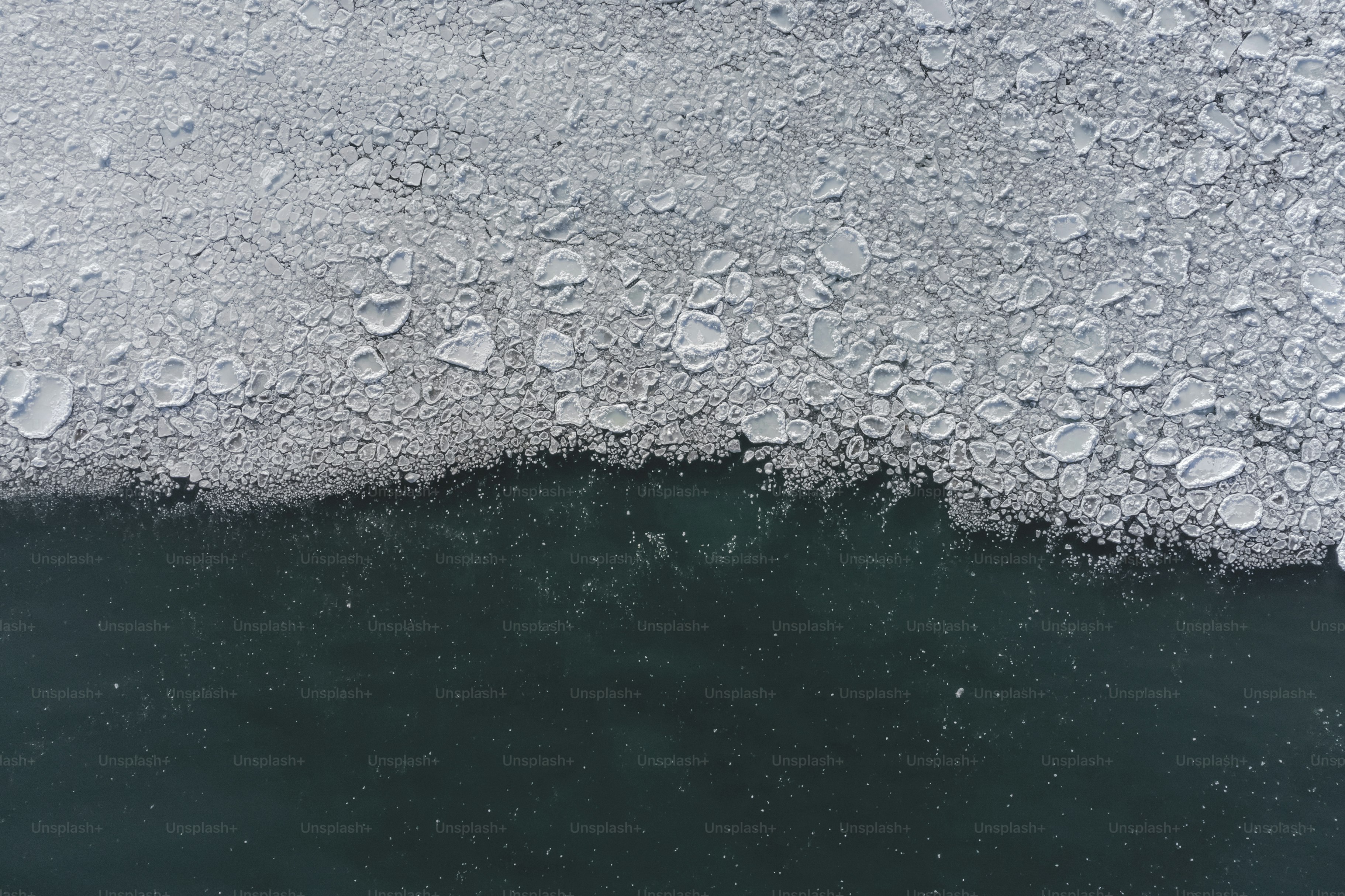 a large amount of ice floating on top of a body of water