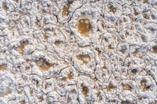 a snow covered surface with small patches of snow