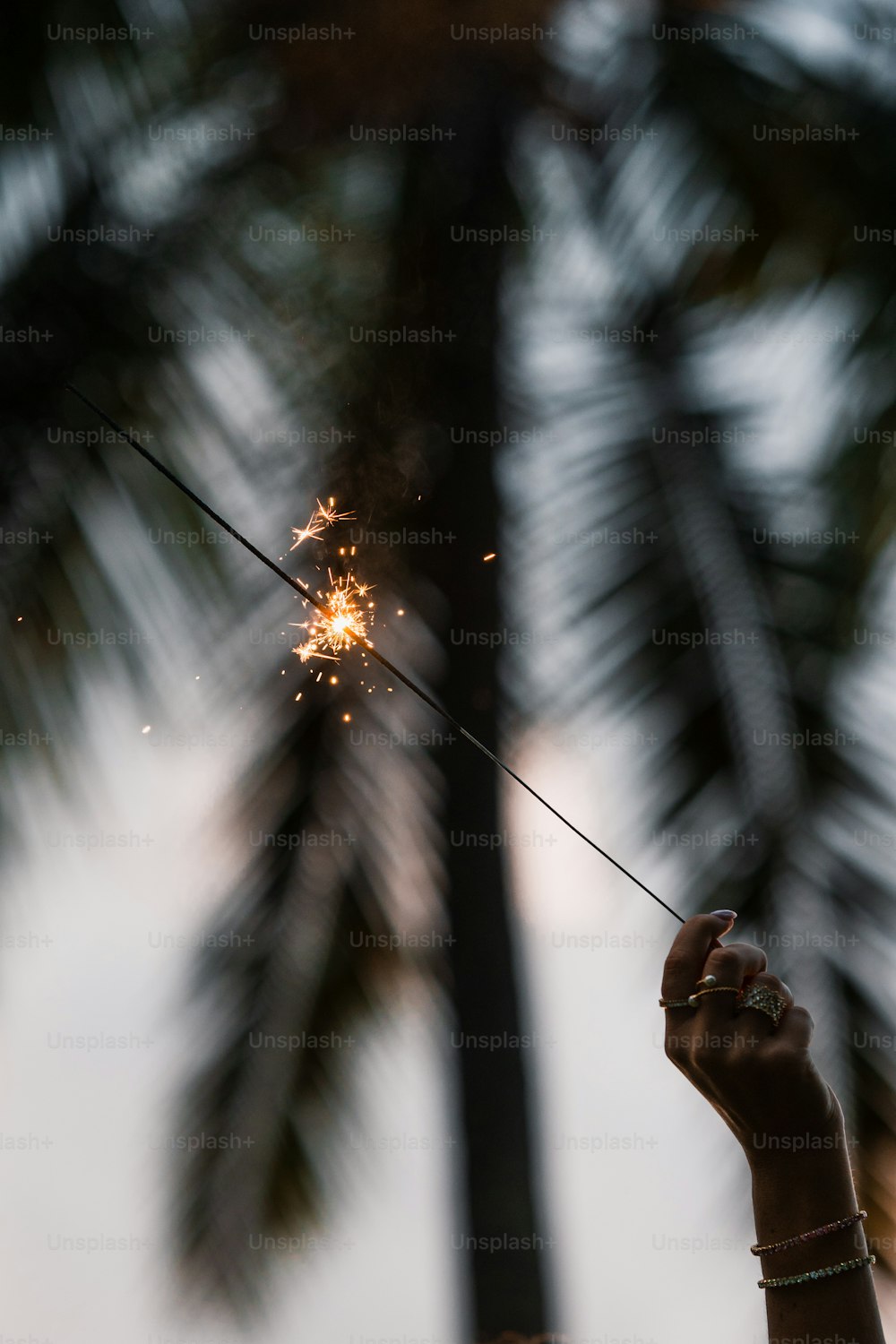 a person holding a sparkler in their hand