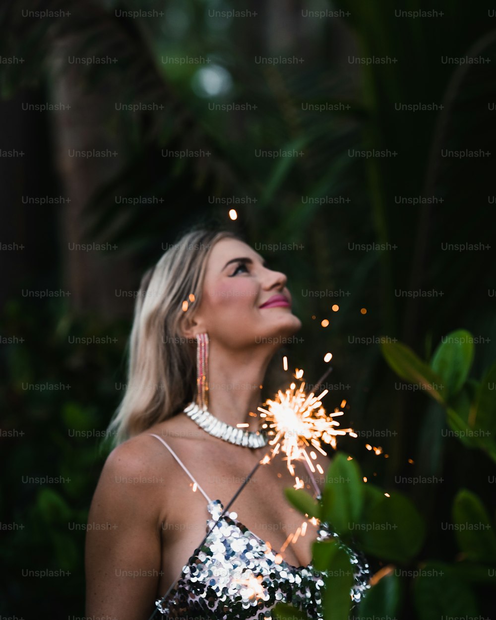 a woman holding a sparkler in her hand