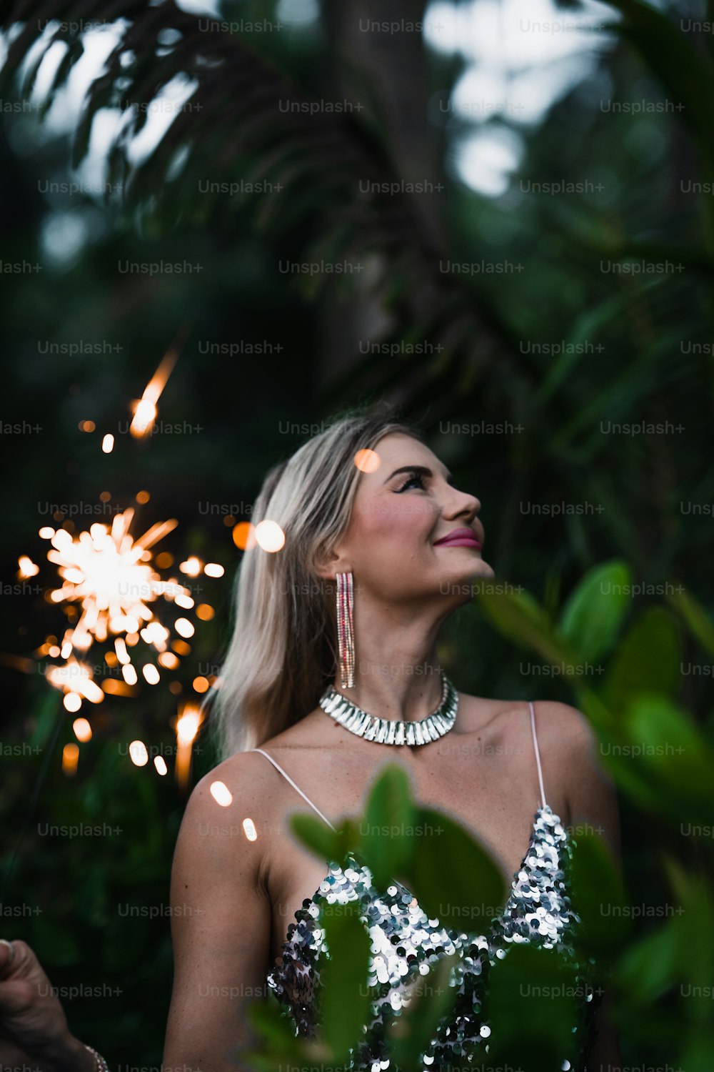 a woman standing in front of a firework