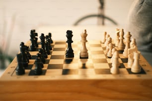 a wooden chess board with pieces on it