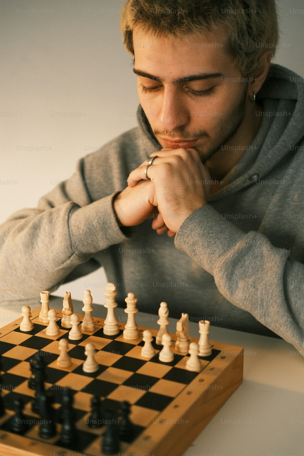 a man sitting at a table playing a game of chess