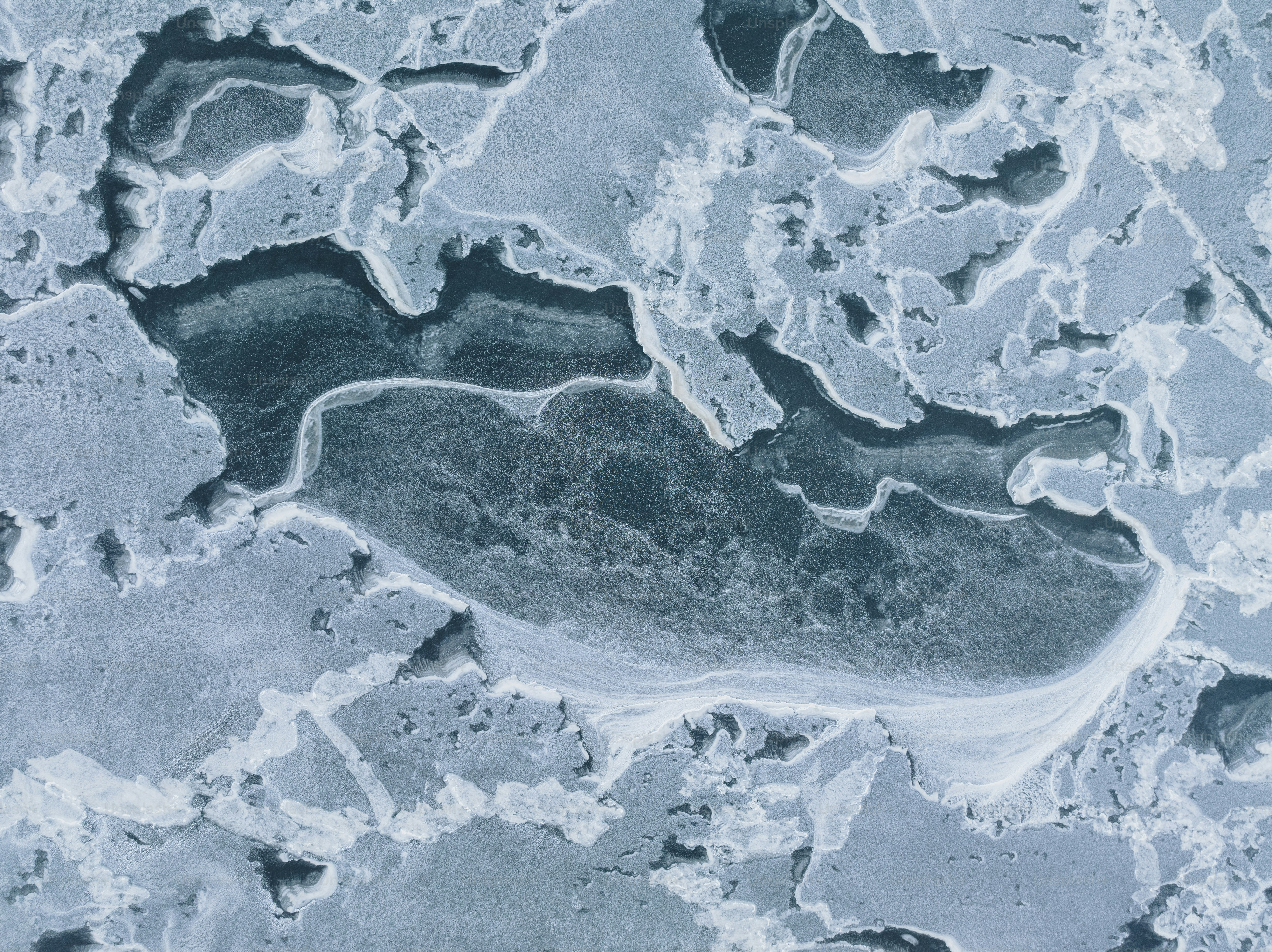 an aerial view of a frozen lake in the middle of winter
