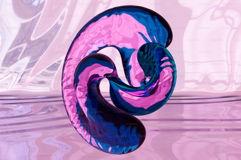 a pink and blue swirl shaped object floating in water