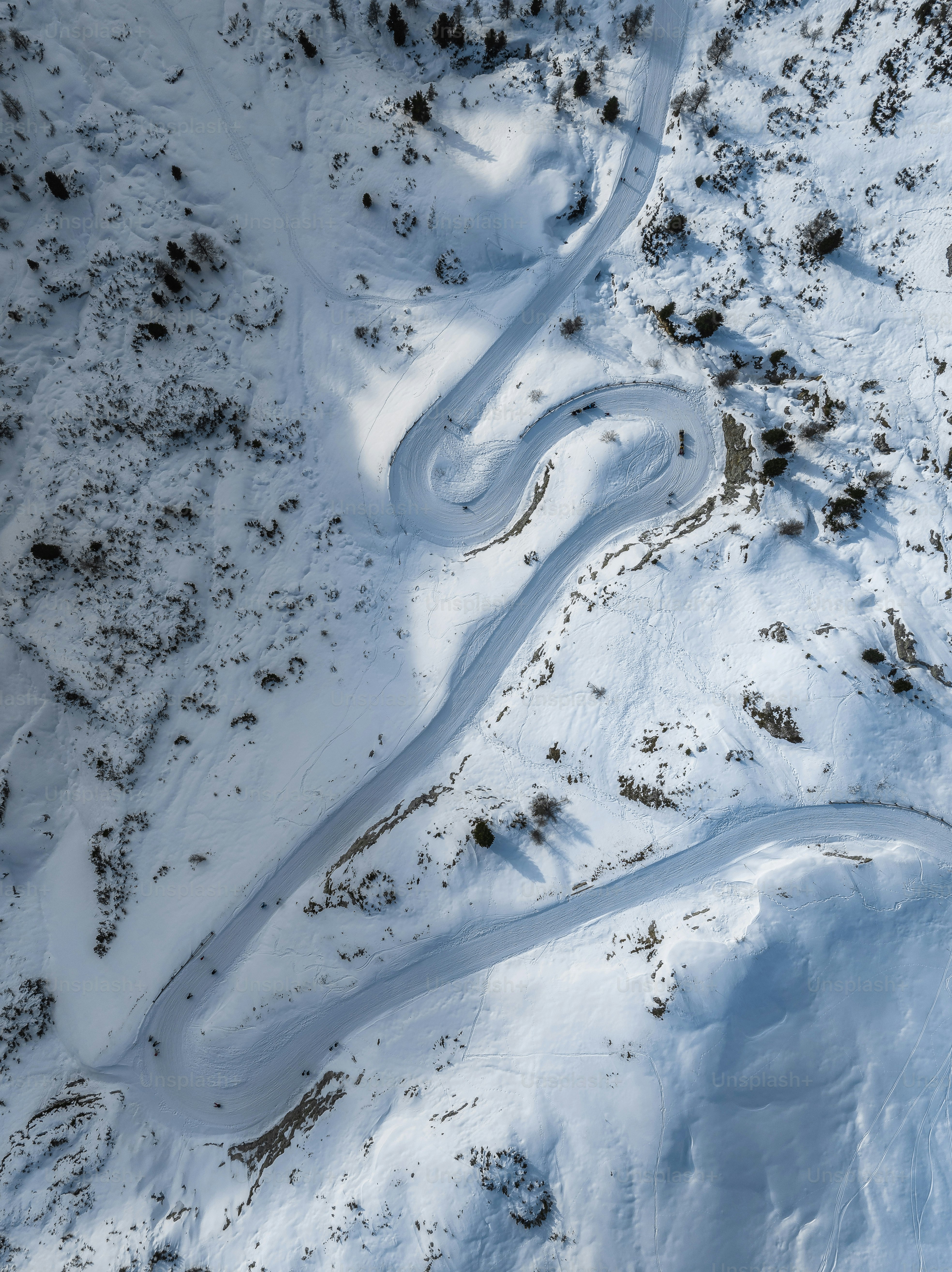 an aerial view of a road in the snow