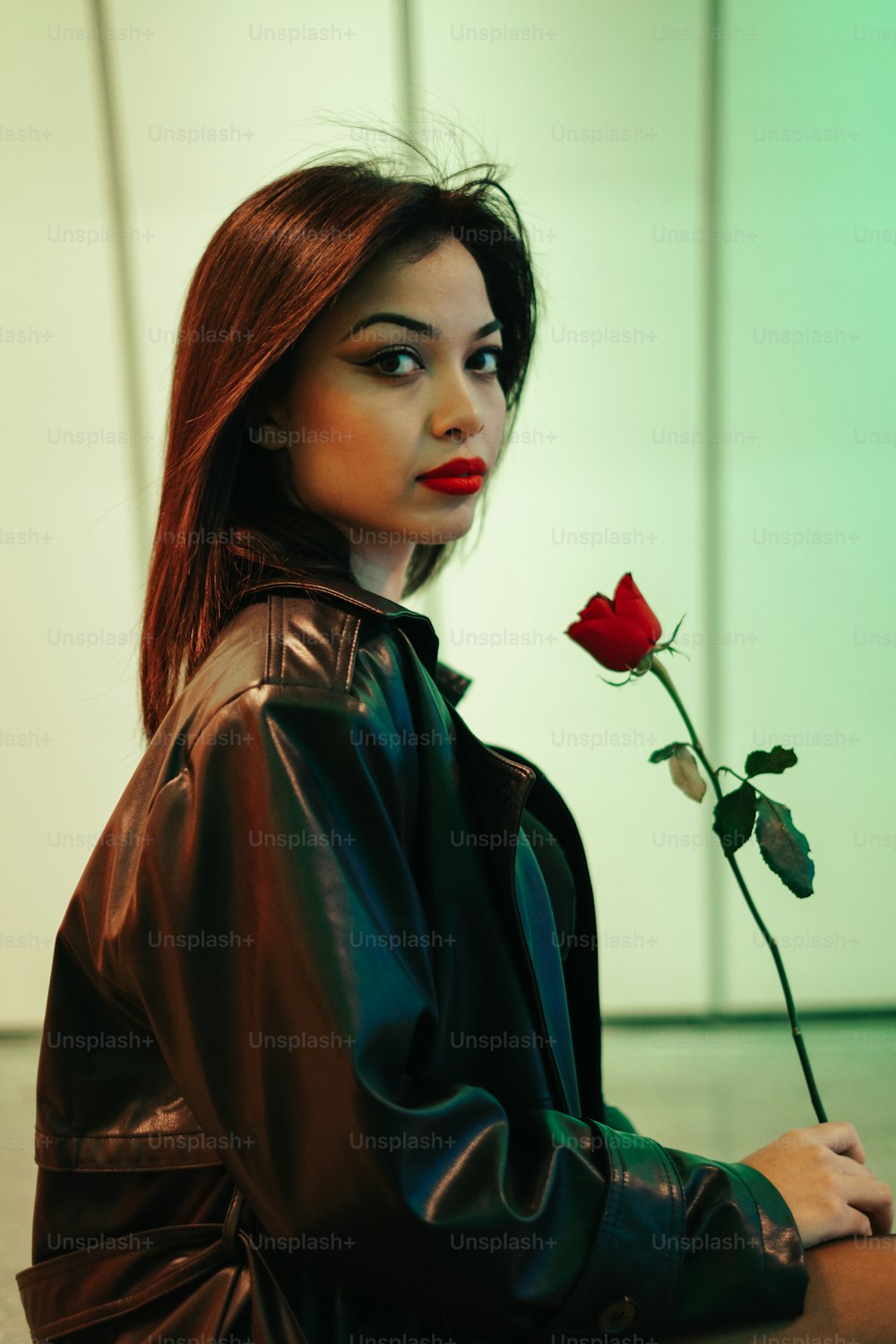 a woman with a red rose in her hand