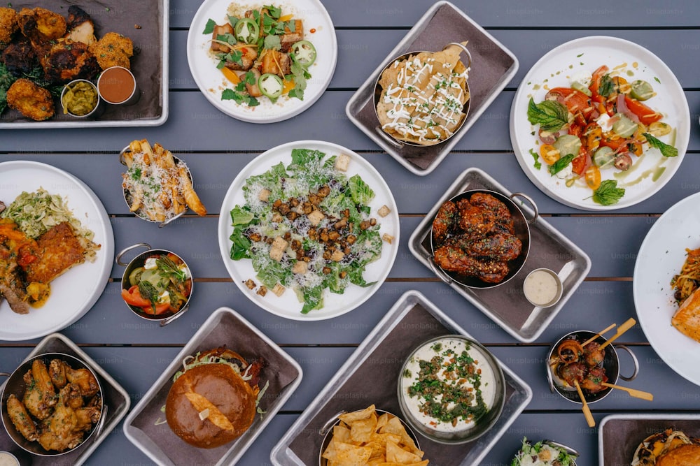 a table topped with lots of plates of food