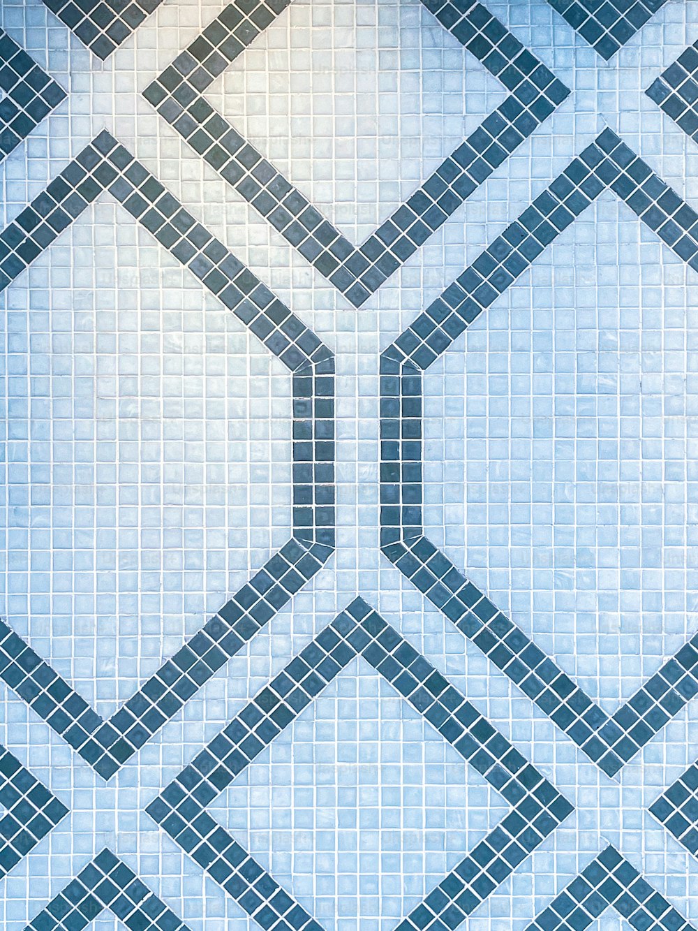 a tiled wall with a blue and white pattern