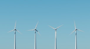 a row of wind turbines against a blue sky