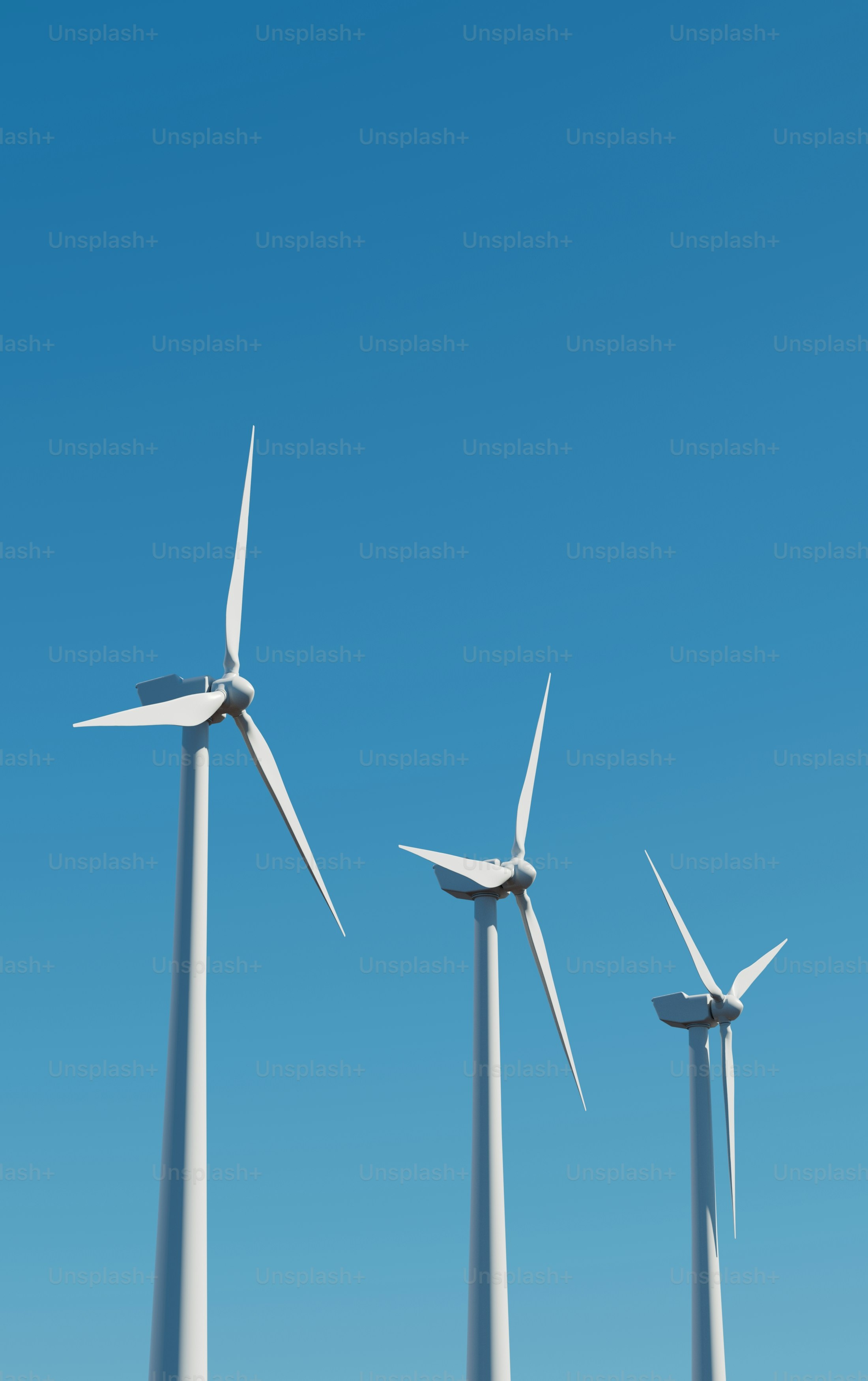 A row of wind turbines against a blue sky photo – Wallpaper Image on ...