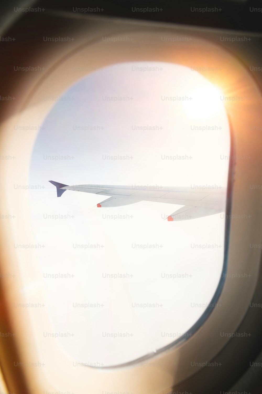 a view of the wing of an airplane through a window