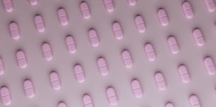 pink pills arranged in rows on a white surface