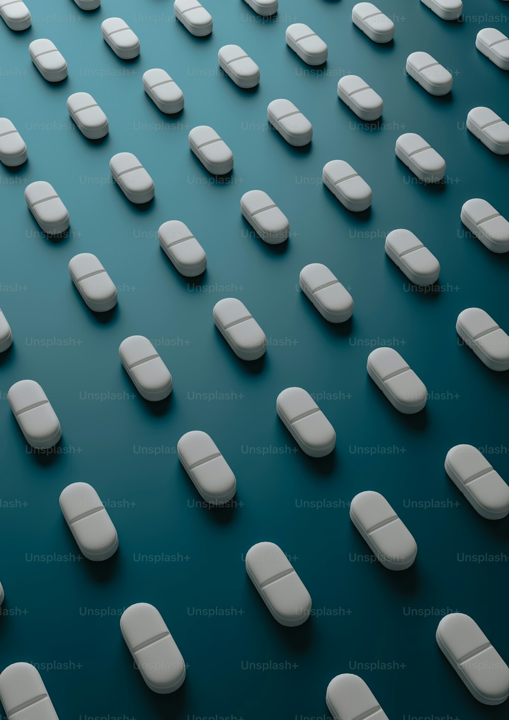 a large group of pills sitting on top of a blue surface