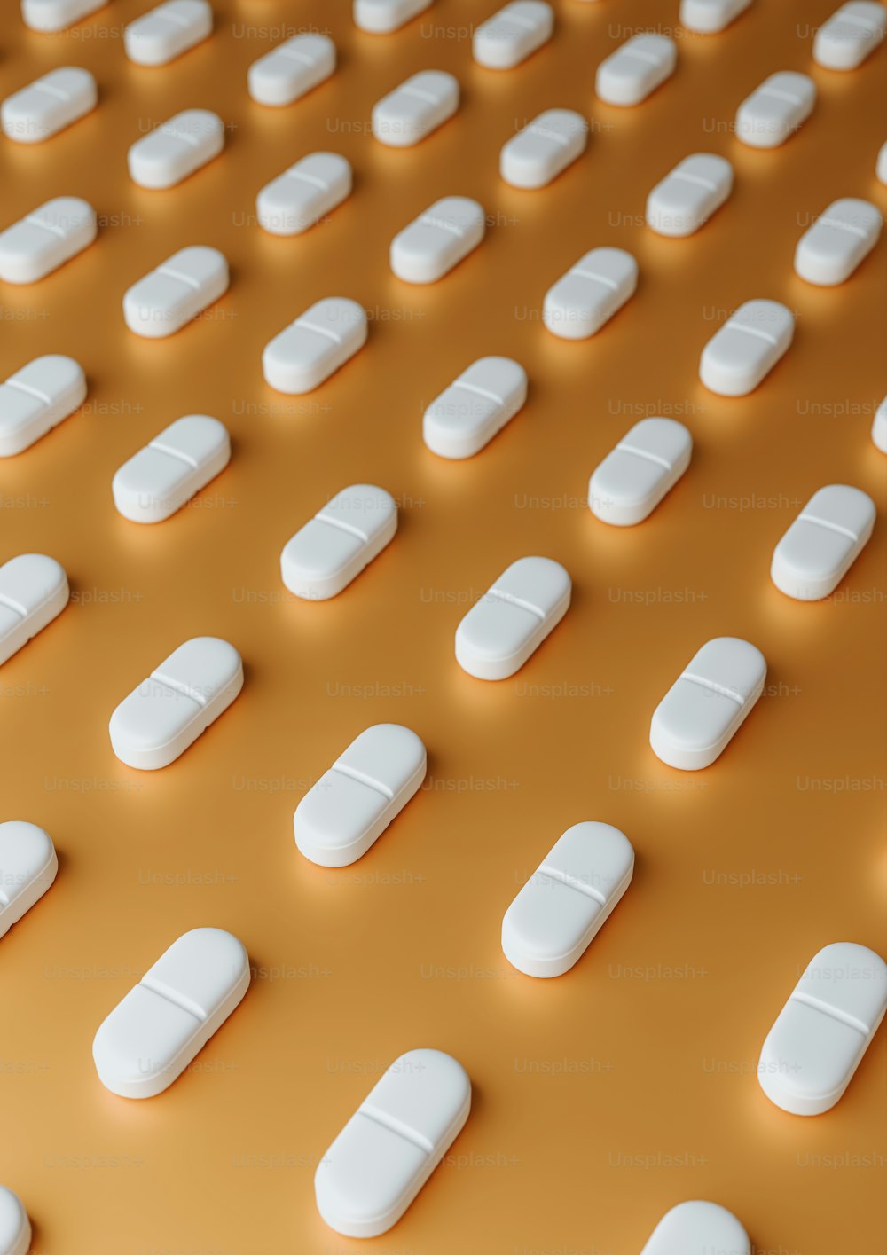 a large group of white pills sitting on top of a table