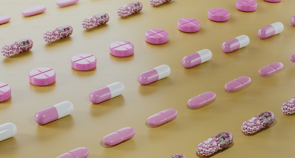 pink and white pills lined up on a table