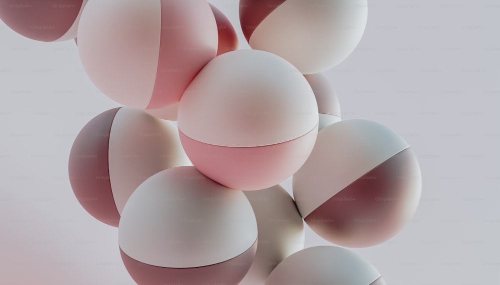 a bunch of white and pink balls floating in the air