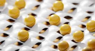 a group of yellow and white balls sitting on top of each other