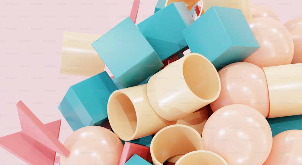 a pile of different colored objects on a pink background