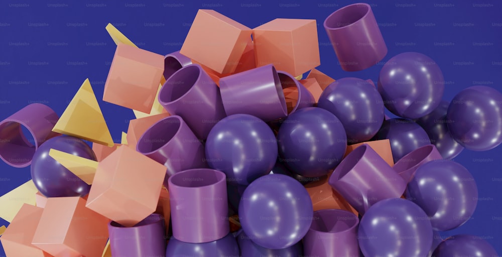 a pile of purple, orange, and yellow balloons