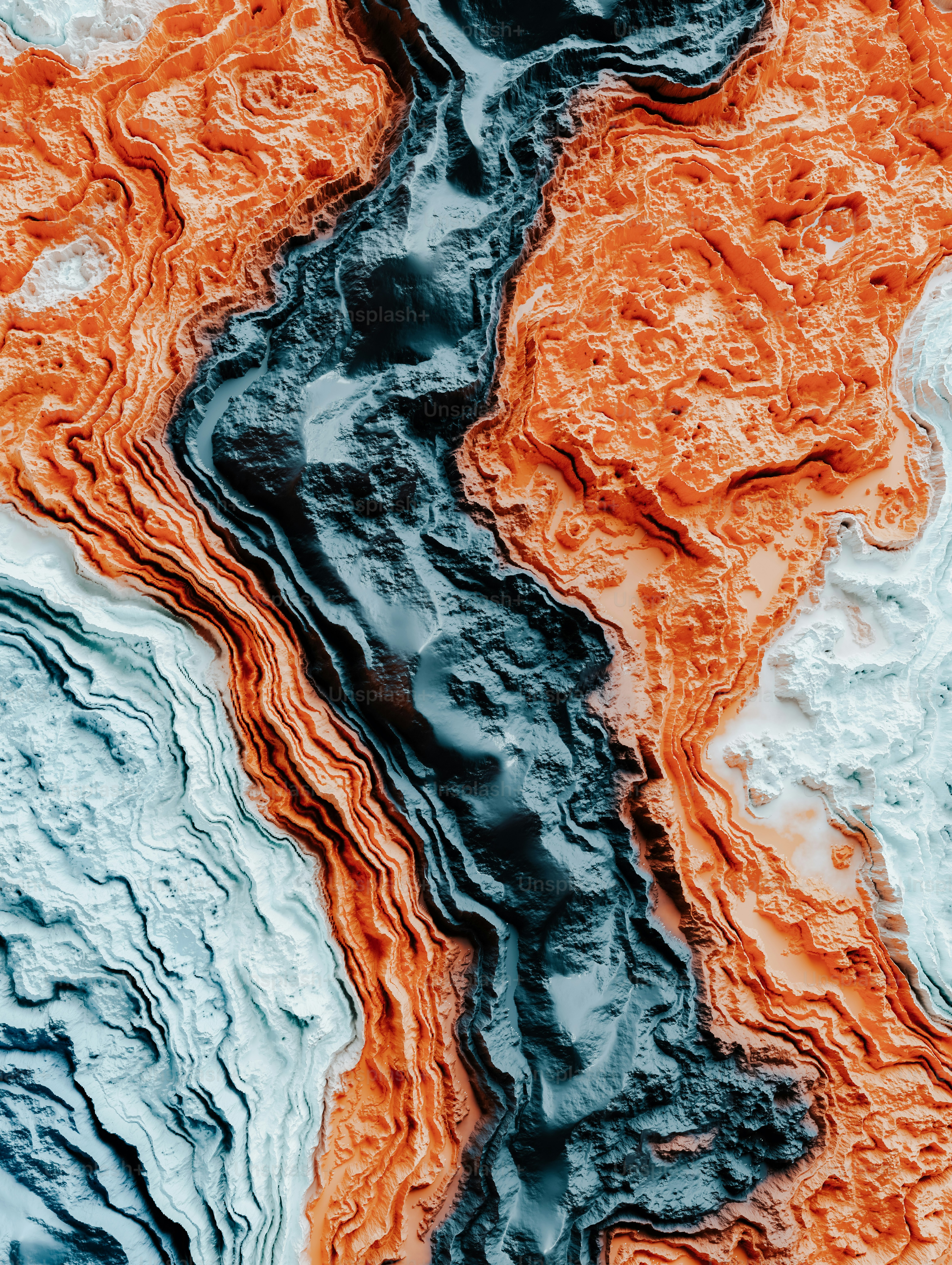 a close up of water with orange and blue colors