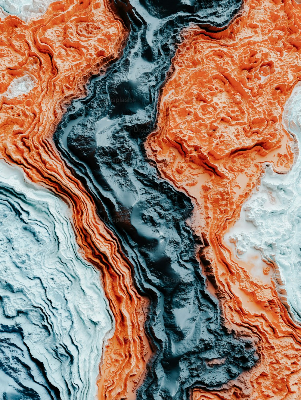 a close up of water with orange and blue colors
