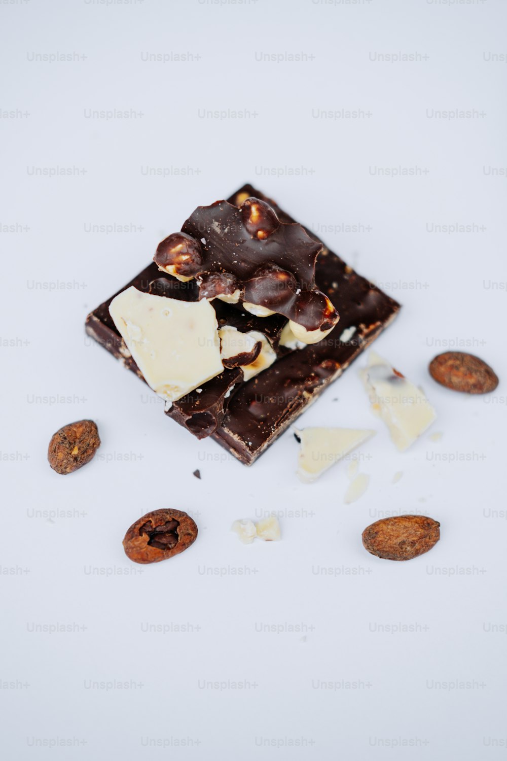pieces of chocolate and nuts on a white surface