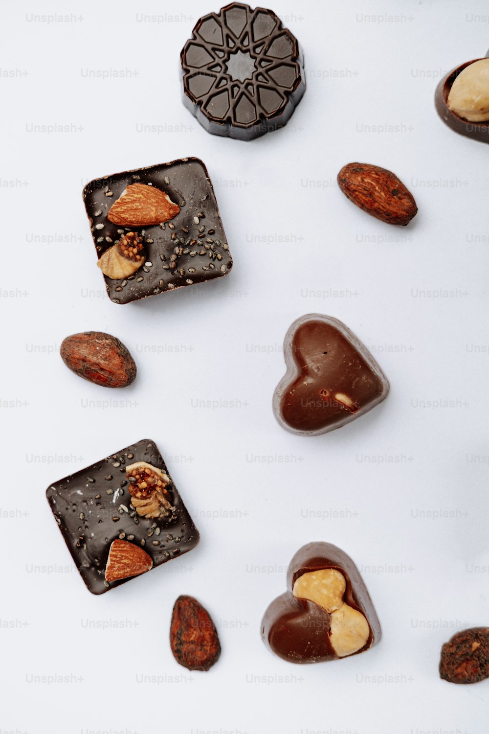 a white table topped with assorted chocolates and nuts