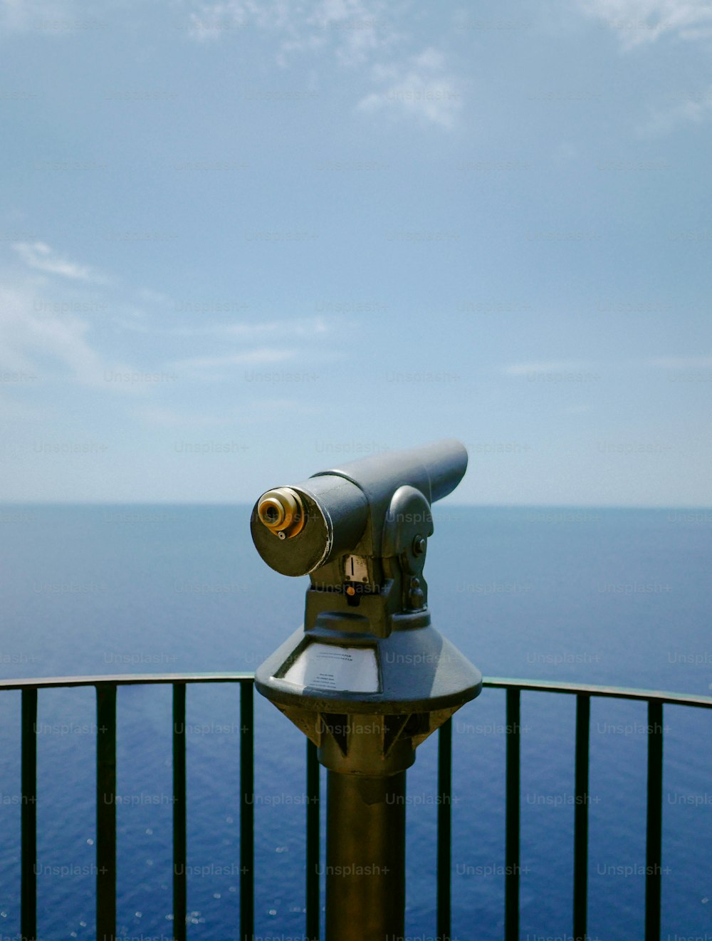 a telescope sitting on top of a metal pole