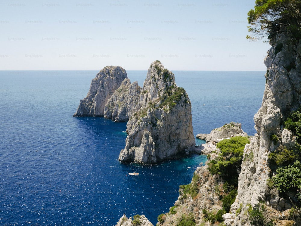 a group of rocks in the middle of the ocean