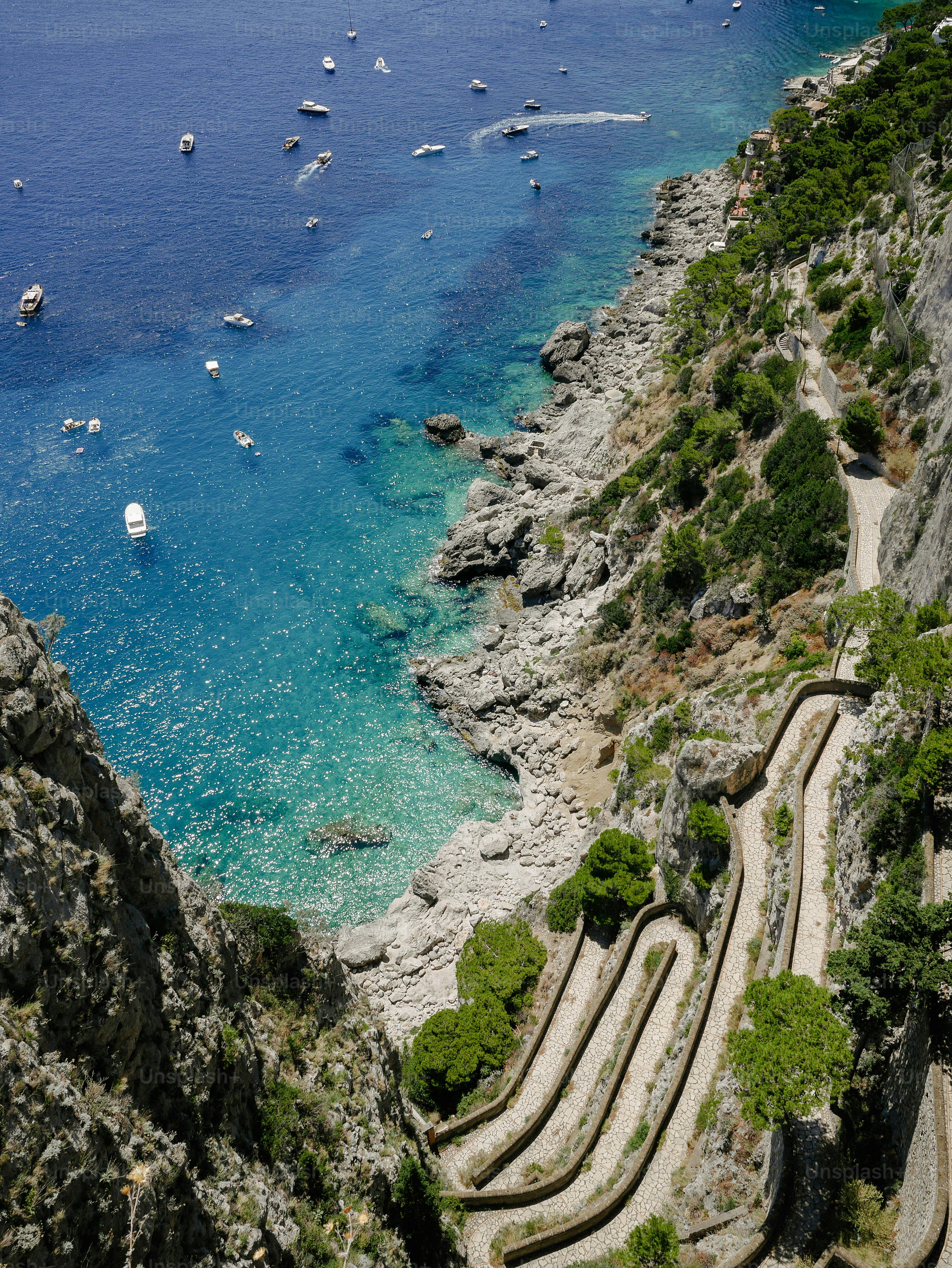 a scenic view of a beach with boats in the water
