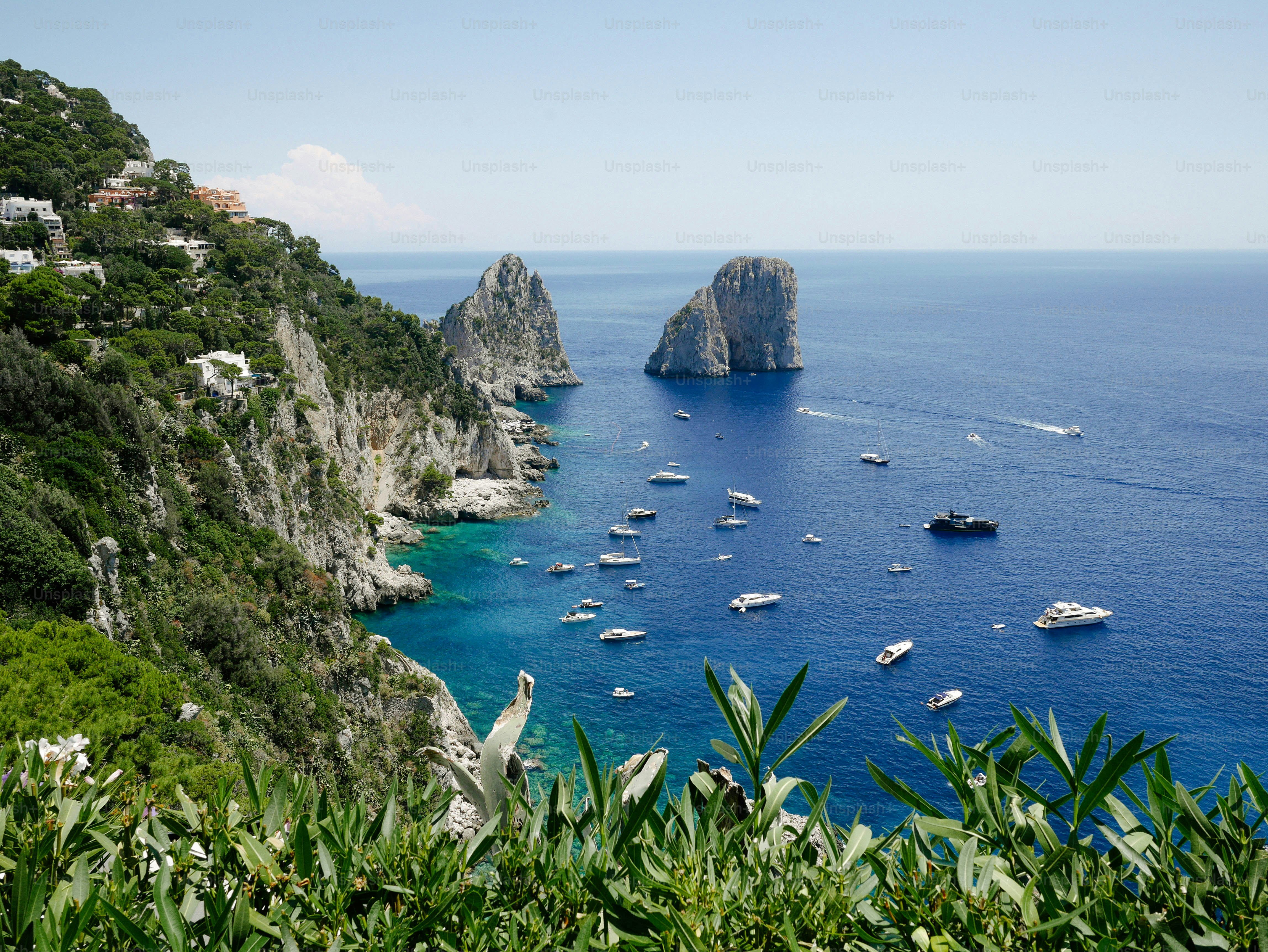a group of boats floating on top of a body of water
