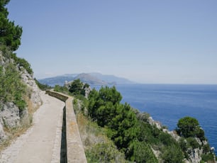 a road on the side of a cliff overlooking the ocean