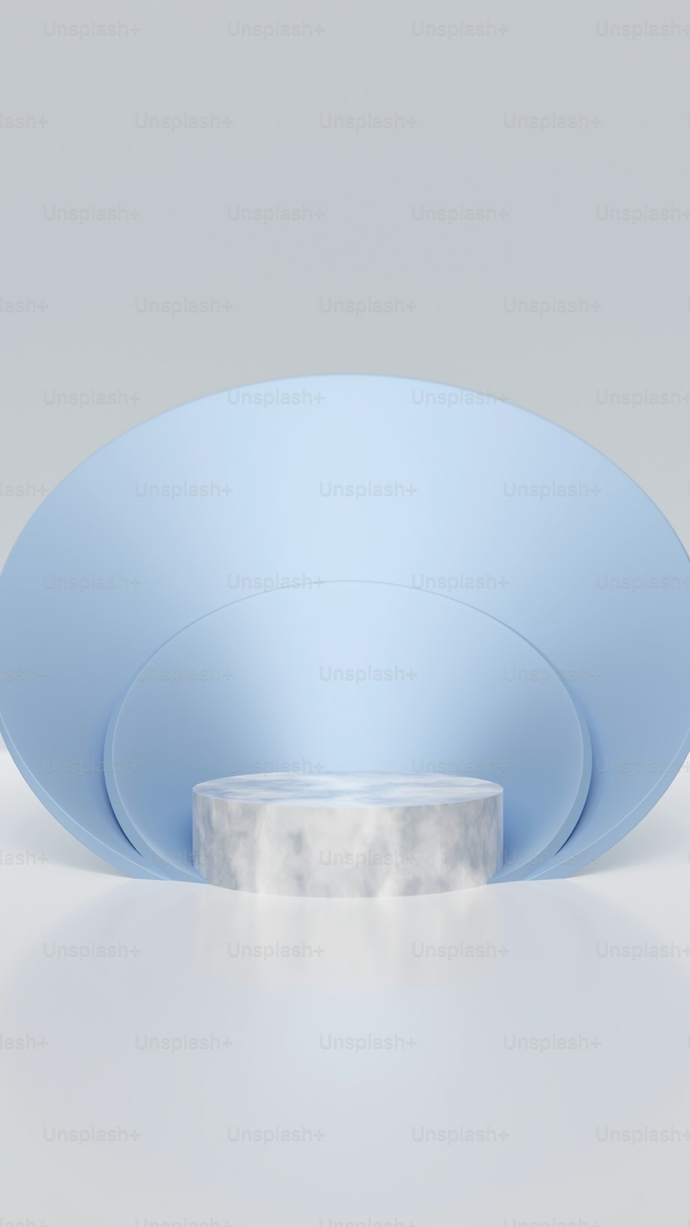 a blue bowl with a white base on a white surface