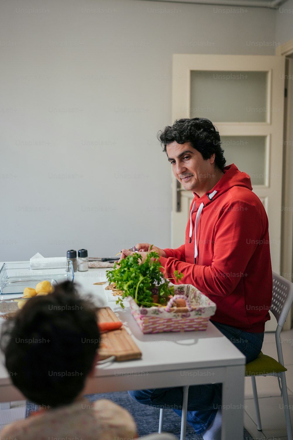 a man sitting at a table with a tray of food