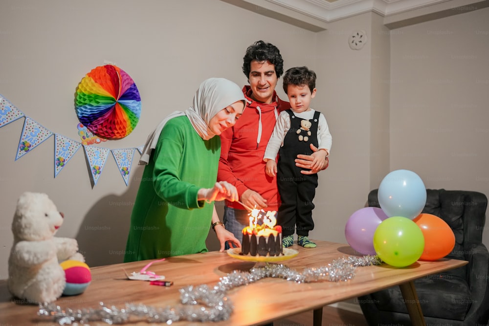 a family celebrating a birthday with a cake