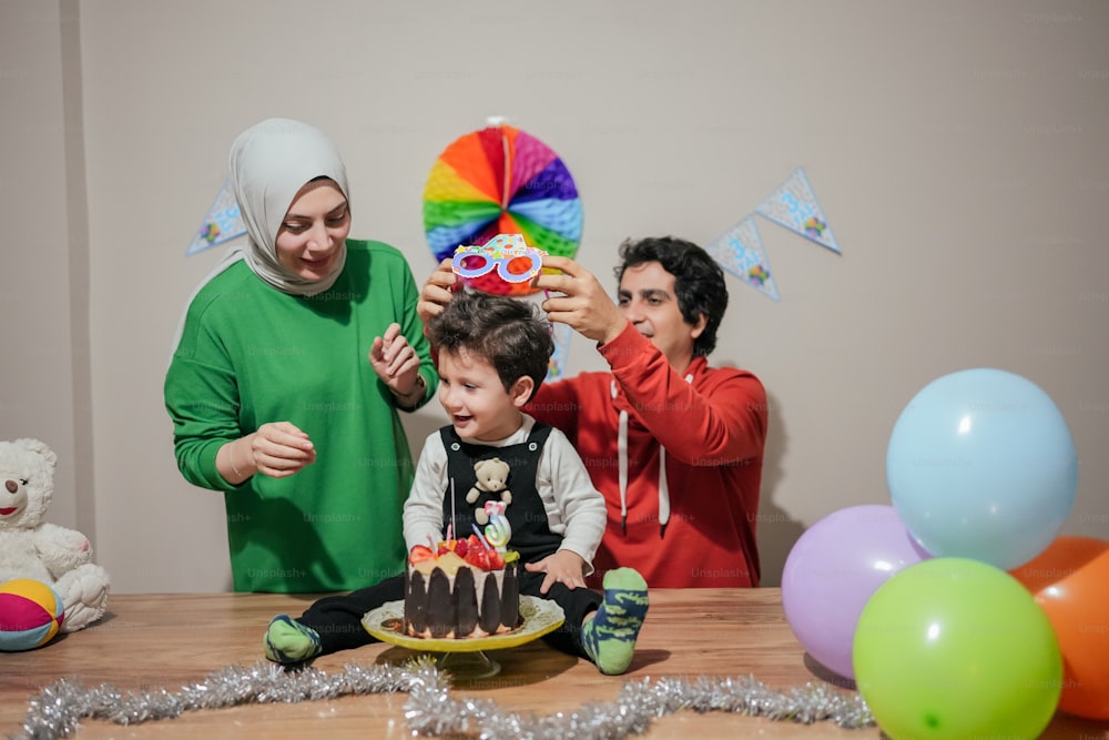 a group of people standing around a cake on a table