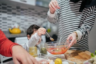 a woman and a child are making food together