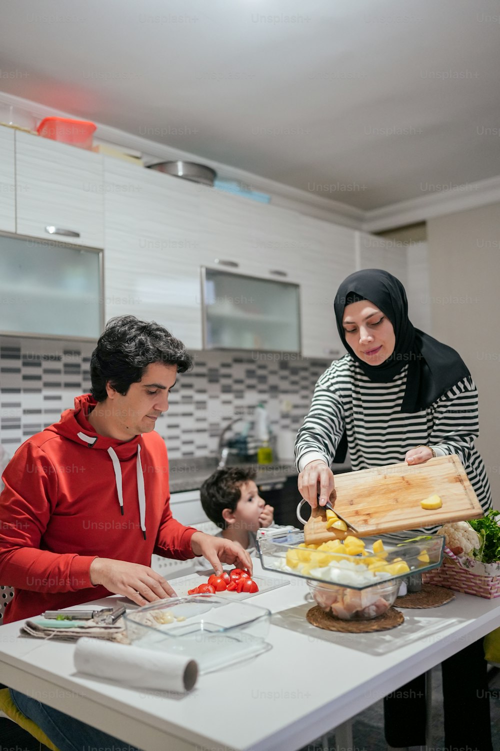 Un uomo e una donna che preparano il cibo in una cucina