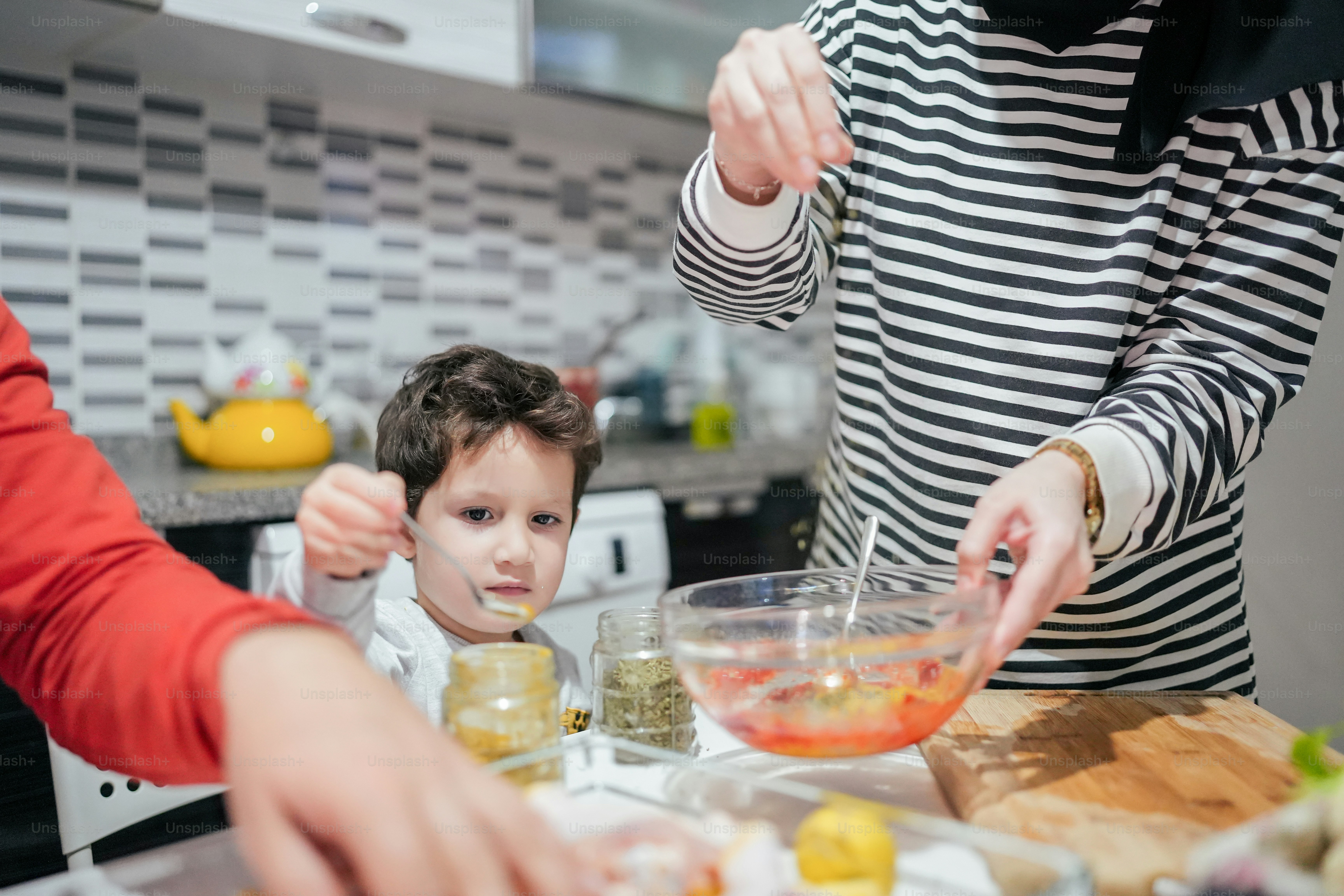 a woman and a child are making food together