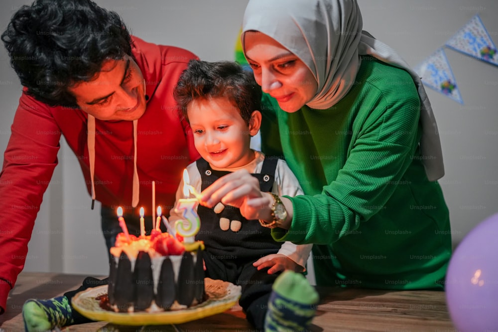 a man and a woman lighting candles on a cake