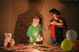 a man and a woman blowing out candles on a cake